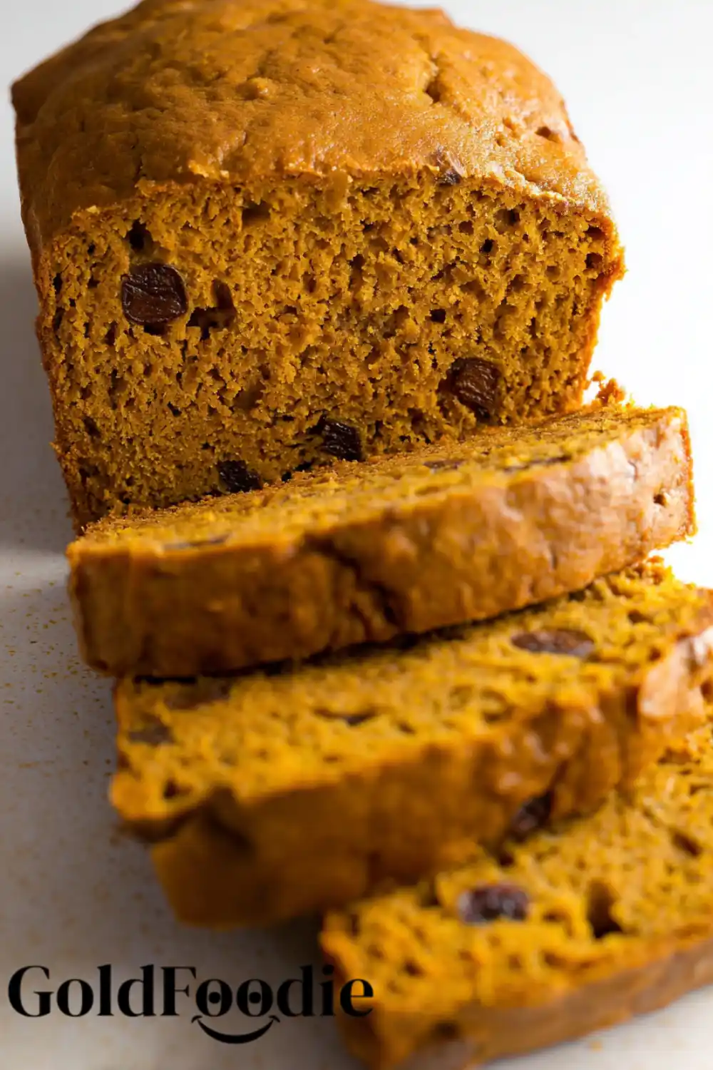 Homemade Pumpkin Banana Bread Thick-sliced pumpkin banana bread loaf on a table.