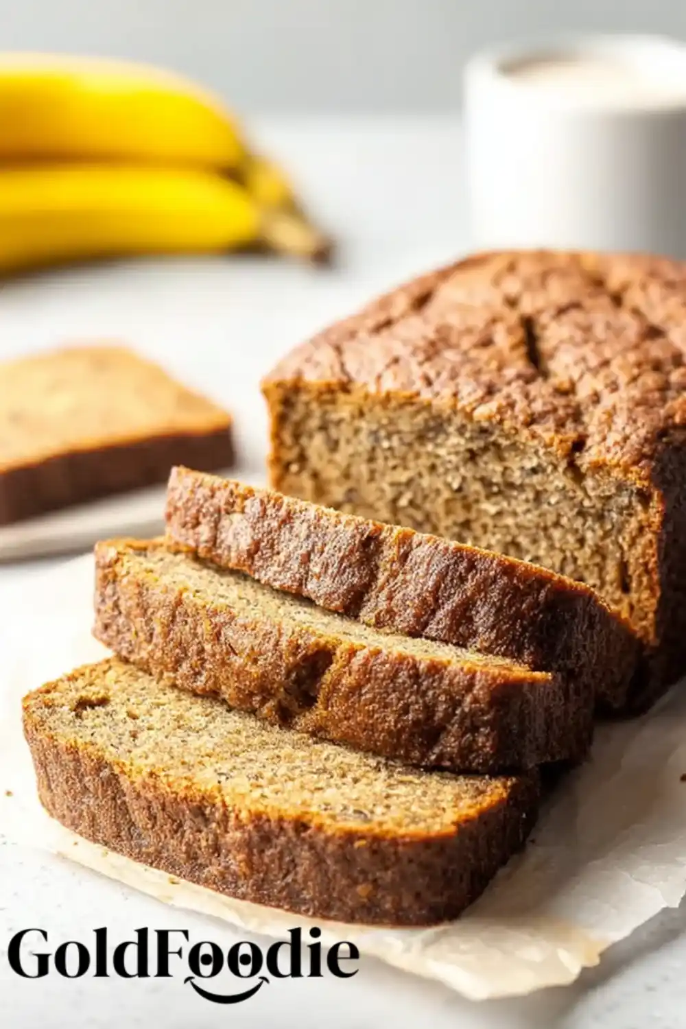 Gluten-Free Vegan Coconut Banana Bread 5 Coconut Banana Bread loaf sliced on parchment with a soft crumb texture.
