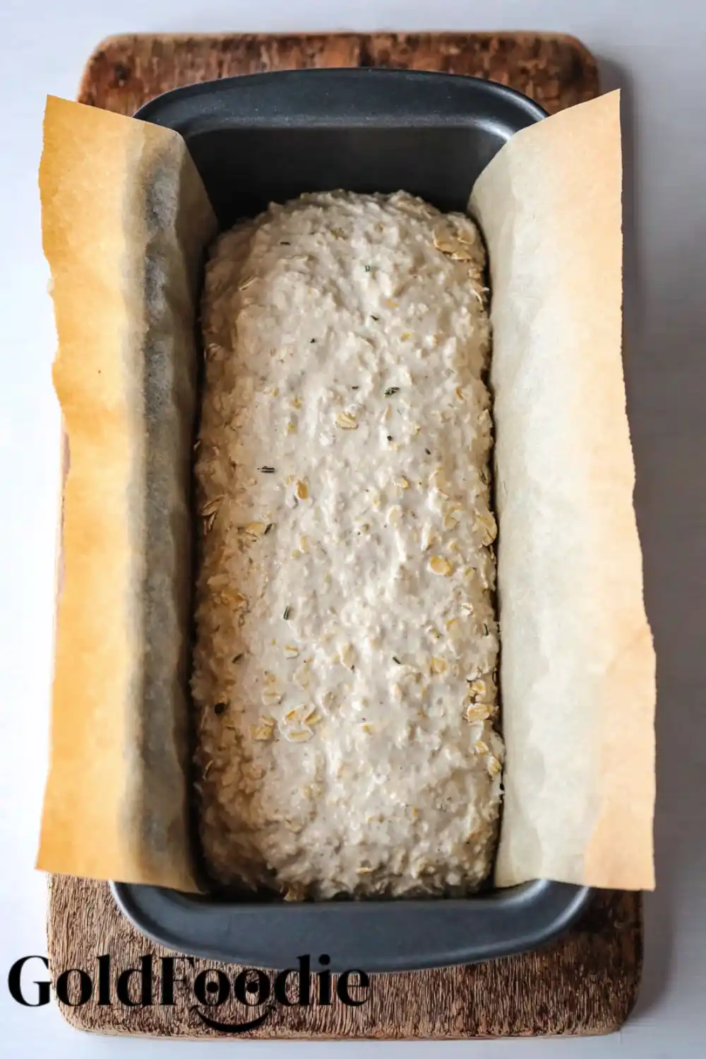 Oatmeal Bread Ready to Bake Unbaked oatmeal bread dough in a loaf pan.