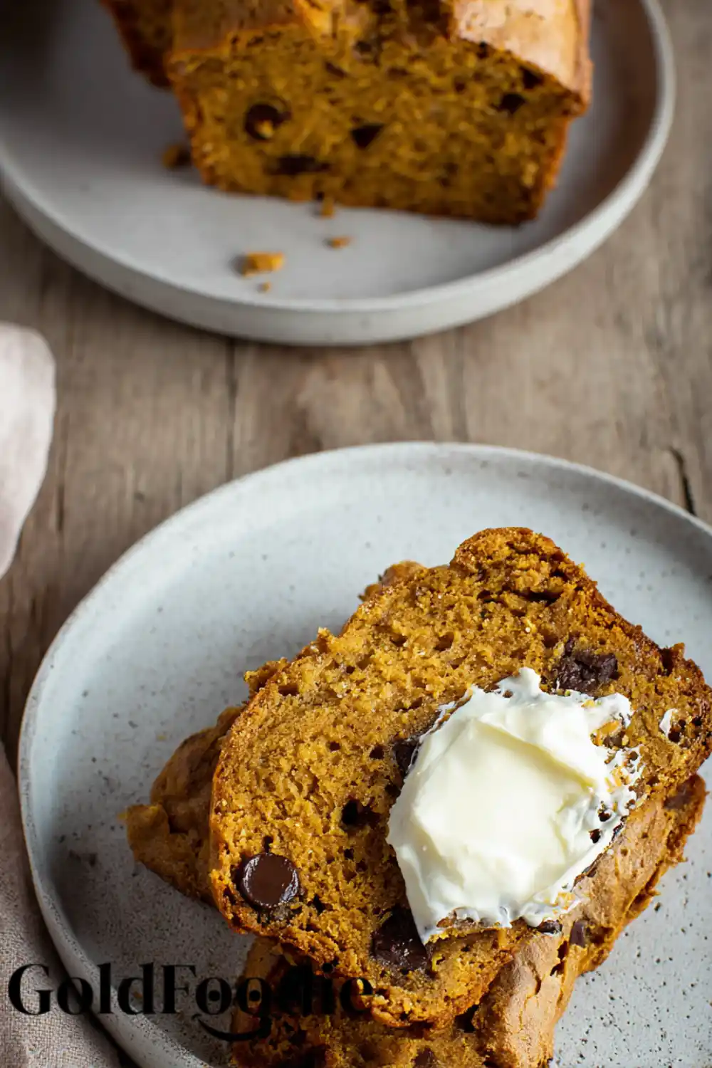 Pumpkin Banana Bread with Cream Cheese Pumpkin banana bread slice with cream cheese spread.