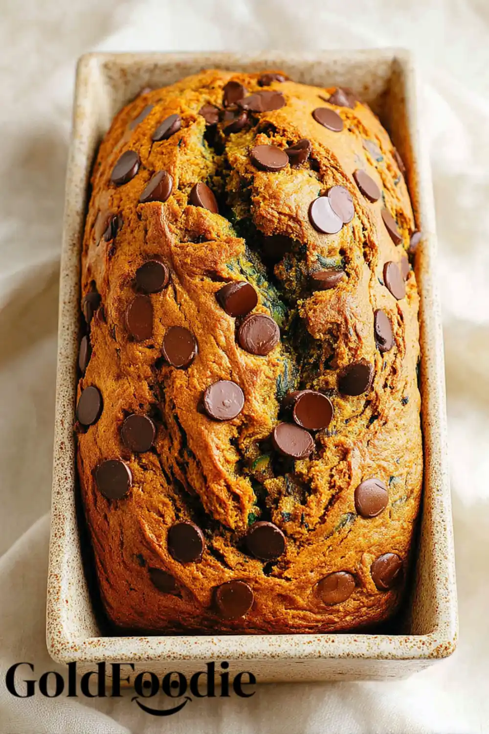 Pumpkin Zucchini Bread in Pan Pumpkin zucchini bread loaf in a baking pan with chocolate chips.