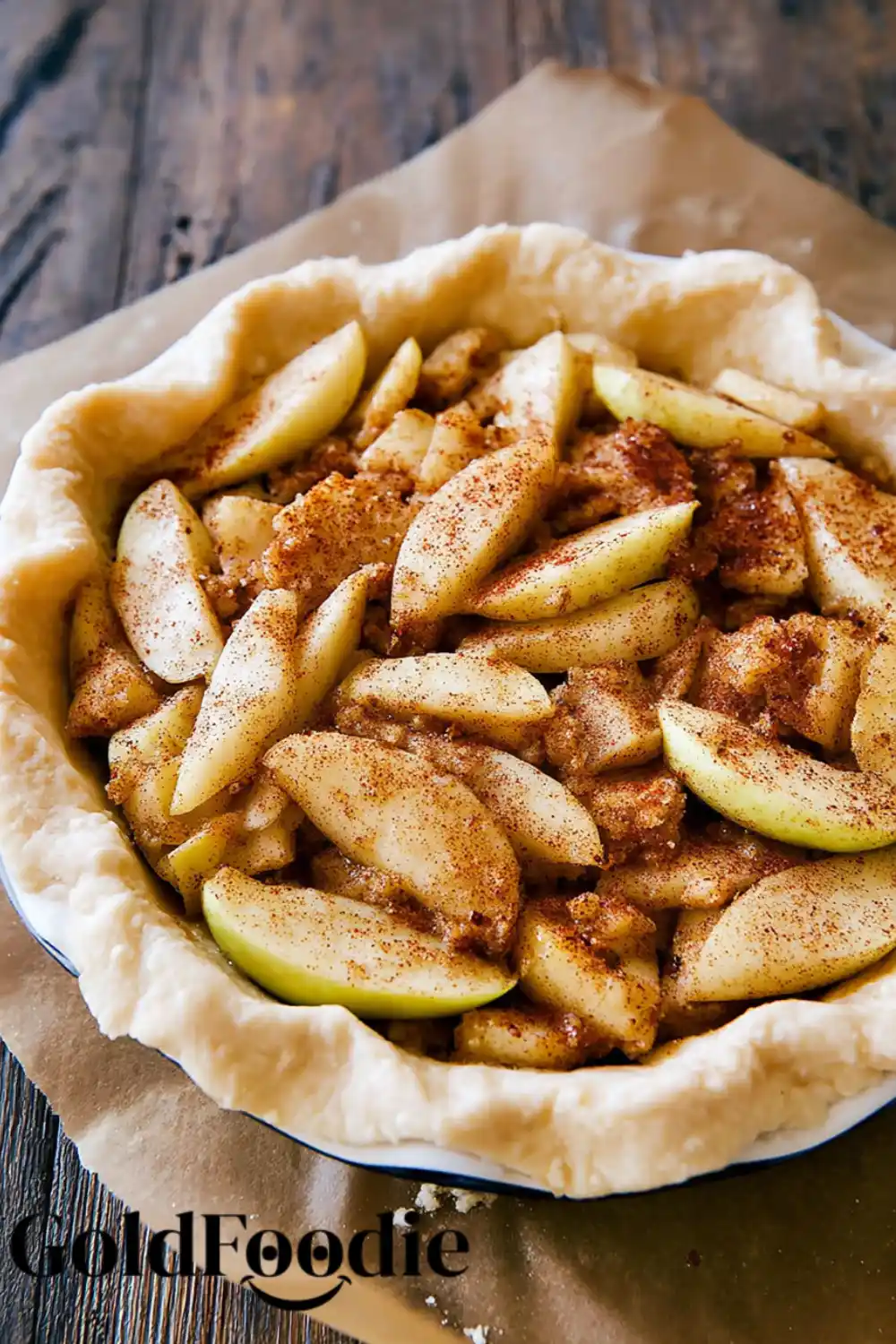Raw Apple Filling in Crust Unbaked pie crust filled with sliced apples and cinnamon
