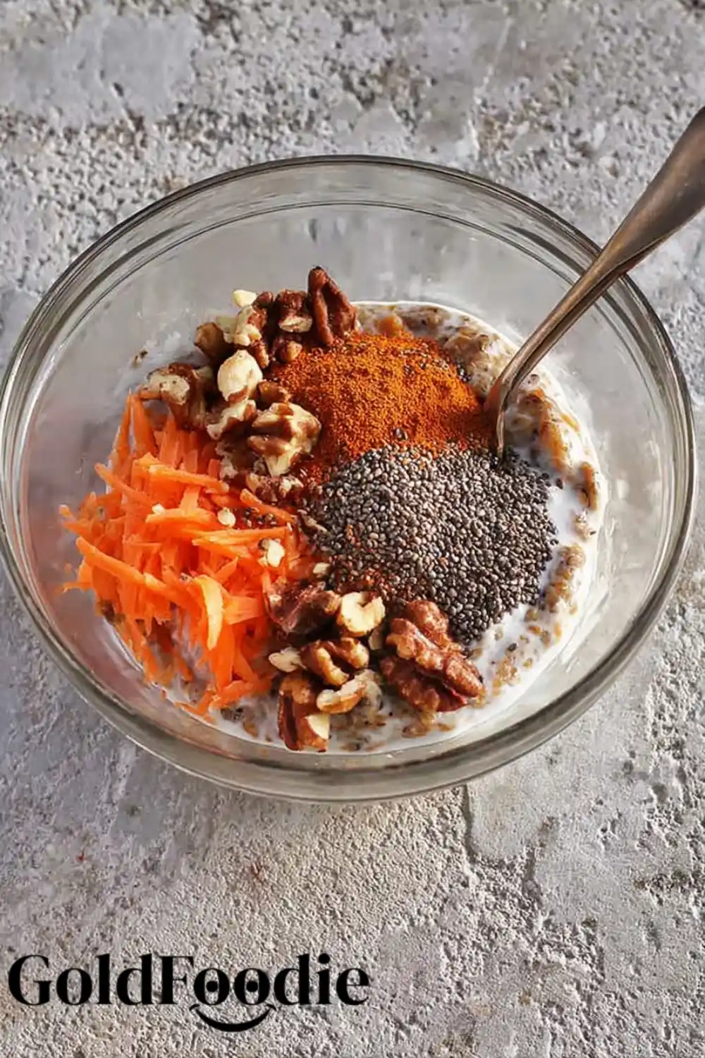 Raw Chia Pudding Ingredients Unmixed ingredients in a bowl including chia seeds, shredded carrots, walnuts, and spices.