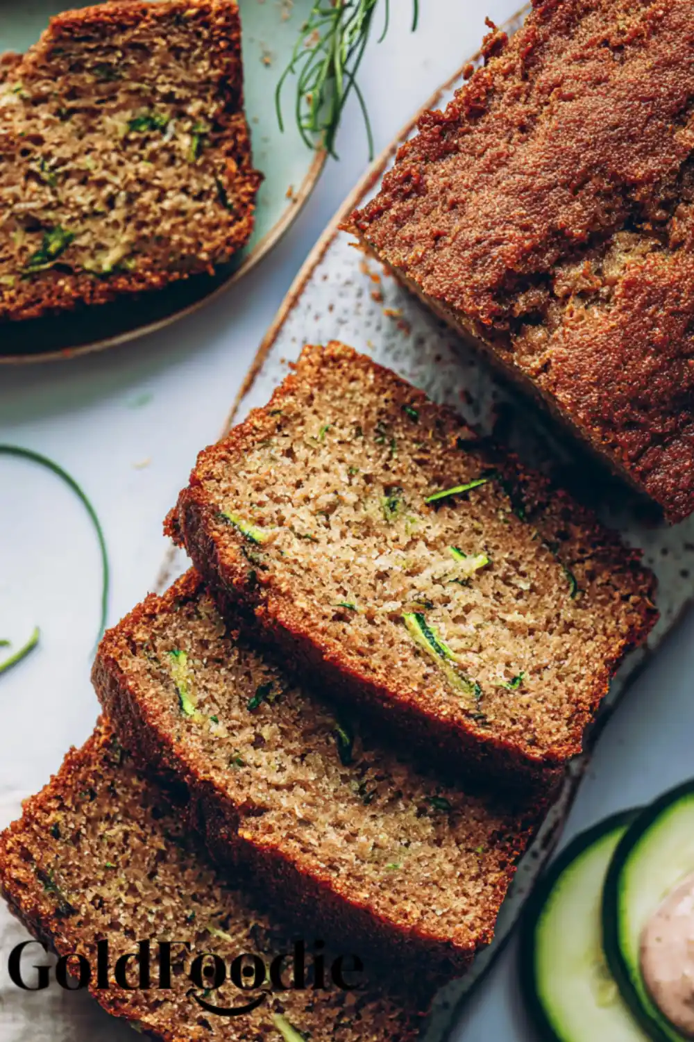 Gluten Free Vegan Zucchini Bread 5 Sliced vegan zucchini bread on a platter with fresh zucchini slices.