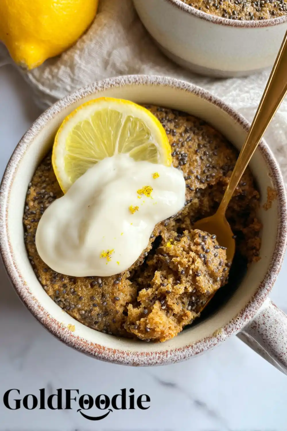 Spoon-In Chia Mug Cake Chia seed mug cake with spoonful taken out and lemon topping