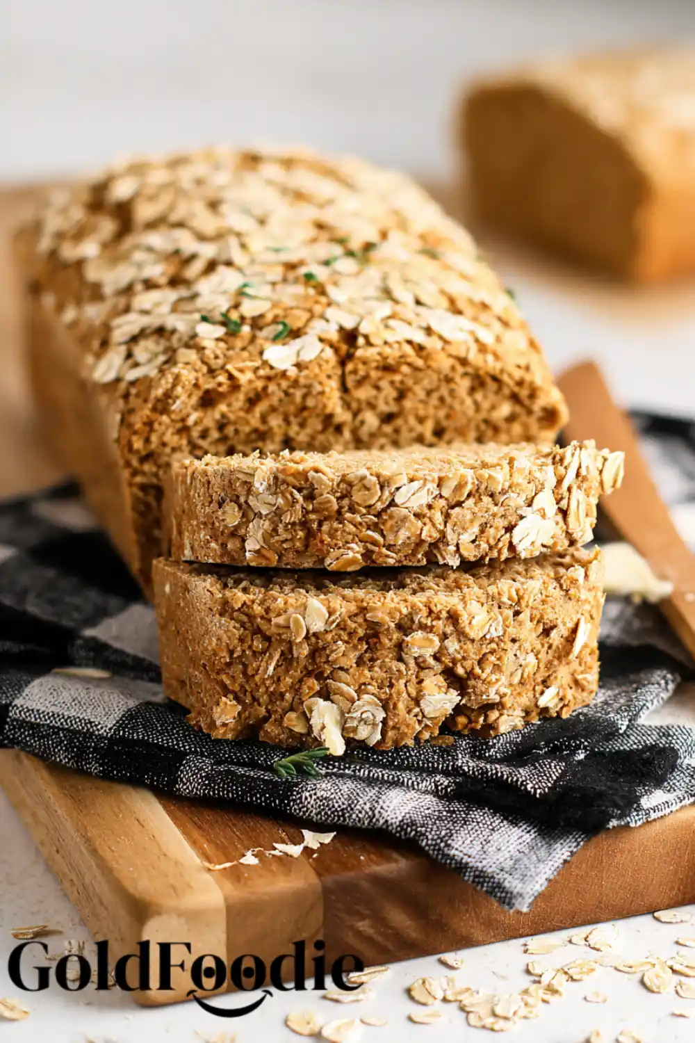Whole Grain Oat Bread Oat bread loaf resting on a cloth-covered board.